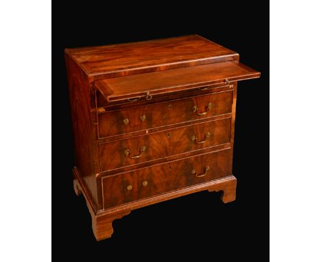 A George III mahogany caddy top bachelors chest, crossbanded top with moulded edge above a slide and four long graduated cock