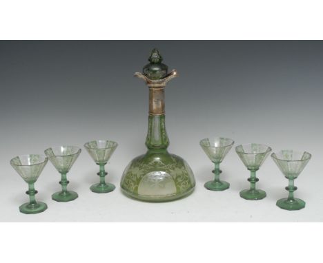 An early 20th century Bohemian green overlaid decanter and six glasses, engraved with four oval cartouches with windmills, th