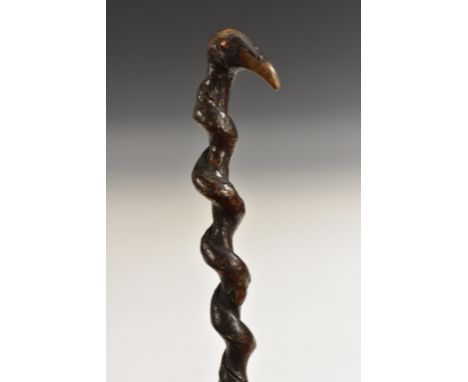 A 19th century novelty 'hedgerow folk art' walking stick, the pommel as the head of a stylised bird, brass pins to eyes, spir