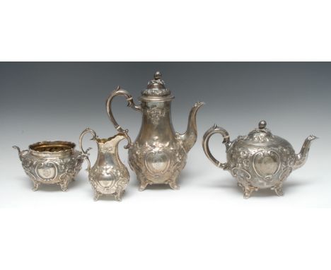 A Victorian silver four piece tea service, comprising teapot, milk jug, sugar bowl and coffee pot, each embossed with foliate