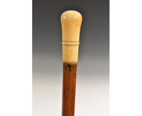 An early 18th century gentleman's ivory and malacca walking stick, lift-off turned domed handle centred by a girdle above a l