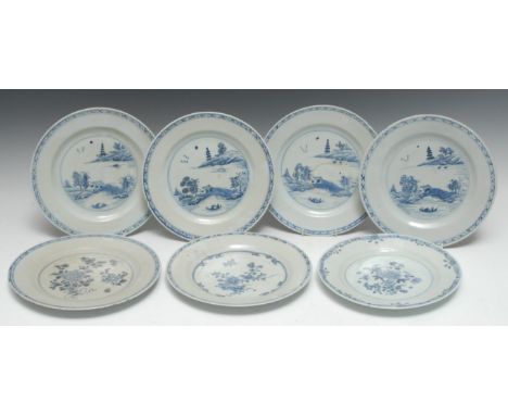 A set of four Chinese circular plates, decorated in underglaze blue with hut, pagoda, sampan, trees and foliage, diaper borde