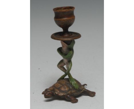 An Austrian cold-painted bronze novelty candlestick, as an upright frog riding a tortoise, the comic tableau surmounted by a 