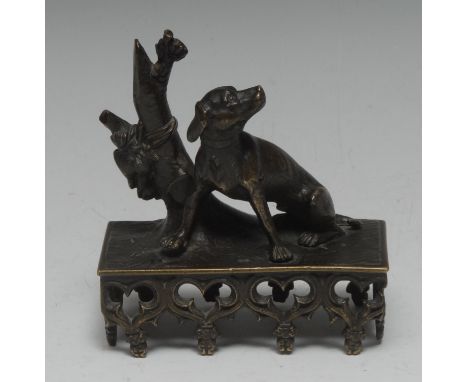 A Regency brown-patinated library bronze, of a faithful hound by a tree stump, rectangular base, Gothick Perpendicular trefoi