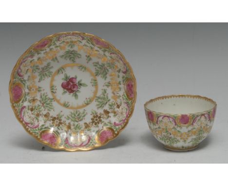 A Worcester fluted tea bowl and saucer, decorated after Sèvres in the manner of James Giles, with green hops and red berries,