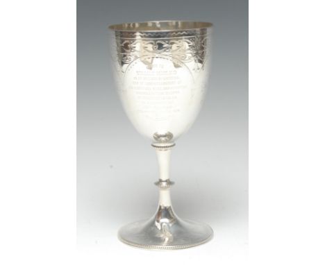 A Victorian silver pedestal goblet, bright-cut engraved with flowers, leaves and bands of heart motifs, knopped stem, circula