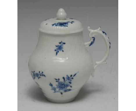 A Tournai baluster mustard pot, painted in underglaze blue with flowering plants and scattered foliage, the neck and shoulder
