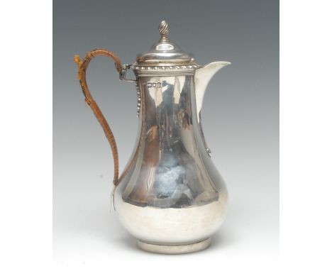 A Victorian silver baluster water jug, hinged cover with spiral-knop finial, gadrooned rim, wicker-wrapped scroll handle, 22.