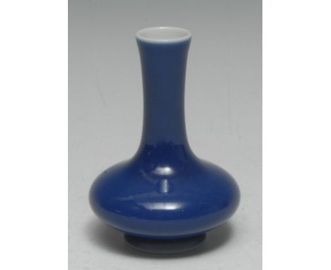 A Chinese monochrome compressed ovoid vase, glazed in tones of blue, 10cm high, six character mark within a double-circle  