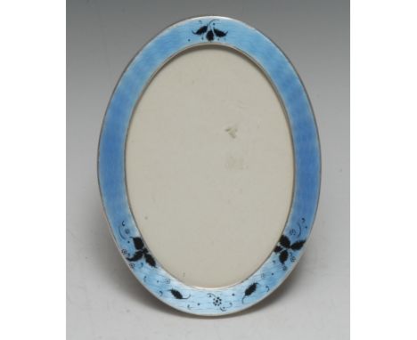 A George V silver and enamel oval easel photograph frame, 17cm high, Birmingham 1911