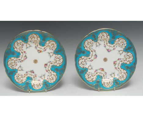 A pair of Minton shaped circular cabinet plates, painted with swags of colourful flowers, turquoise ground, trellis rim, 23cm