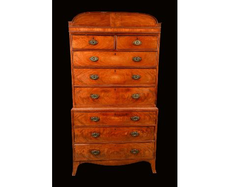 An early 19th century mahogany chest on chest, possibly Channel Islands, the arched cornice outlined with ebony stringing abo