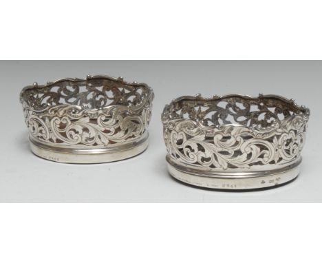 A pair of early Victorian silver circular wine coasters, each deep shaped gallery cased and chased with scrolling foliage, dr