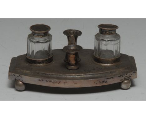 A 19th century Dutch silver bowed rectangular inkstand, glass wells centred by a pair of tapersticks and a conical snuffer, b