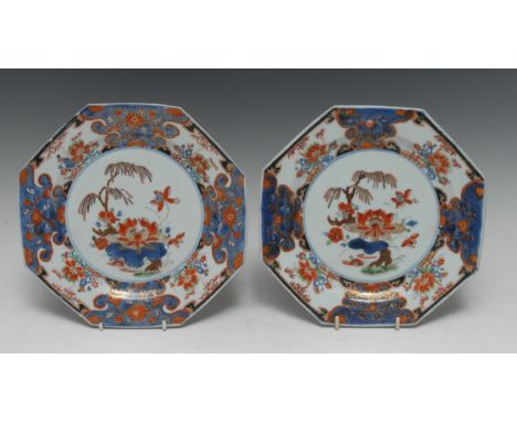 A pair of Chinese Export Imari octagonal plates, painted in underglaze blue and slightly later European over-decorated and 'c