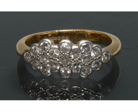 A diamond cluster ring, shaped crest inset with nineteen round brilliant cut diamonds, platinum crest, 18ct gold shank, size 