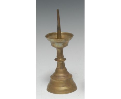 A 16th century brass pricket candlestick, deep dished wax pan, knopped stem, domed circular foot, 19.5cm high, c.1550