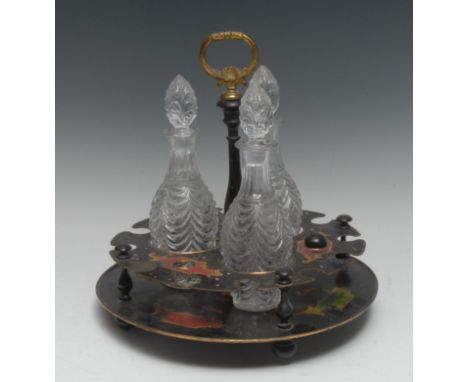 An early 19th century three bottle tole work decanter stand, painted in red, green and yellow with panels and leafy scrolls, 