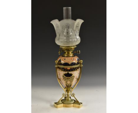 A late Victorian brass  and ceramic ovoid oil lamp,  in the Imari palette, wirework frame, triform base,  acid etched shade, 