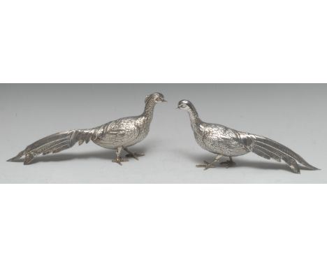 A pair of Continental silver table decorations, as cock and hen pheasants, 27cm and 26cm long, Spanish, early 20th century