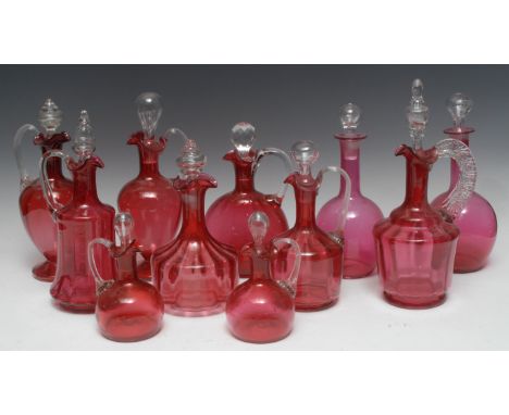 A Victorian cranberry glass decanter, ribbed clear glass handle, clear stopper, 27.5cm high, c.1879;  others, various styles 