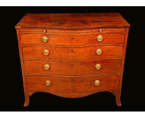 A George III mahogany serpentine bachelors chest, slightly oversailing top above a slide and four long graduated drawers, sha