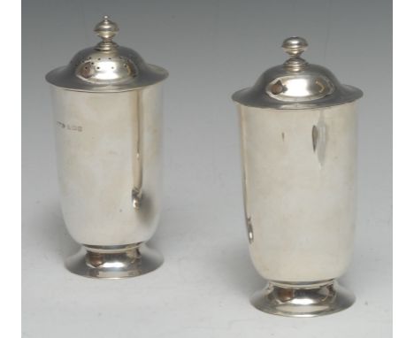 A pair of Arts and Crafts silver sugar casters, domed bayonet-fitting covers pierced for dusting and pouring, skirted bases, 