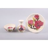 A Moorcroft "Magnolia" pattern bowl, 6 1/4" dia, and a similar vase, 6 1/2" high, and a similar