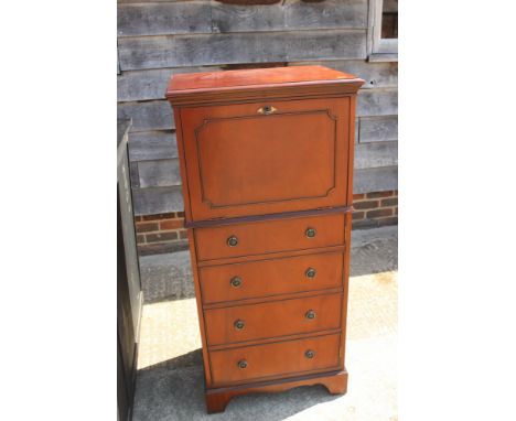 A polished as mahogany drop front cocktail cabinet enclosed four faux drawer front panel doors, on bracket feet, 23" wide x 1