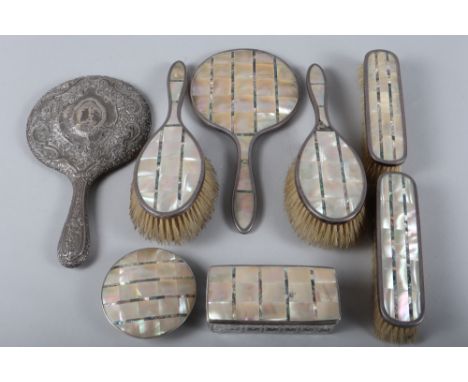 A silver, mother-of-pearl and abalone mounted dressing table set and an embossed white metal mounted dressing table mirror 