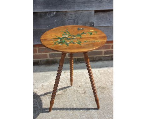 A late 19th century painted olive wood circular top occasional table, inscribed "San Remo", on bobbin turned supports, 17 1/2