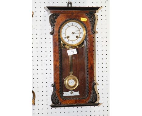 A mahogany and ebonised cased mantel clock with scrolled decoration, white enamelled dial and Roman numerals, 16 1/2" highCon