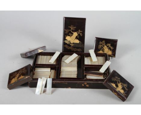 A collection of Chinese engraved mother-of-pearl gaming counters in five lacquered boxes There are approximately 160 shaped c
