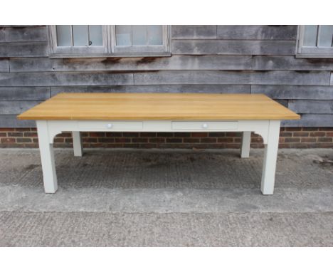 A light oak rectangular topped dining table, fitted four drawers, on white painted chamfered supports, top 96" x 46" 