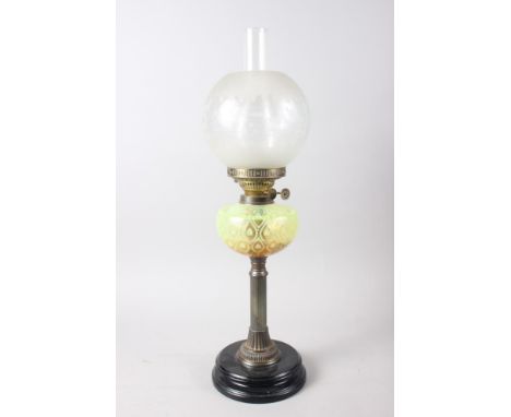 An oil lamp with etched decoration, vaseline coloured glass chamber and fluted brass column, on ebonised stand, 25 1/2" highC