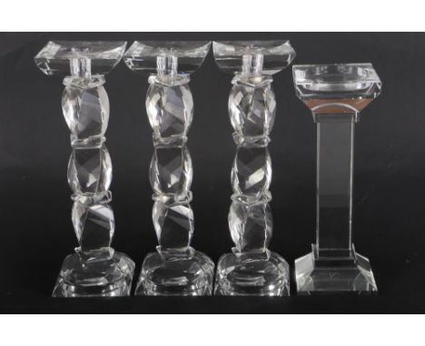 A set of three Kenneth Turner glass candlesticks, on facet cut stems, another plain square-section candlestick, a Brierley cr