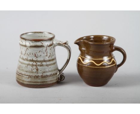 A Leach Pottery jug with trailed slip decoration, 4 1/2" high, and a Leach Pottery mug, 4 3/4" high 