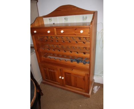 A waxed pine tile back bottle rack with drawers over cupboards, 48" wide x 20" deep x 60" high 