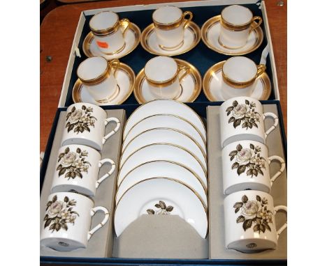 A modern boxed Royal Worcester six place setting coffee service on a white ground, transfer decorated with roses together wit