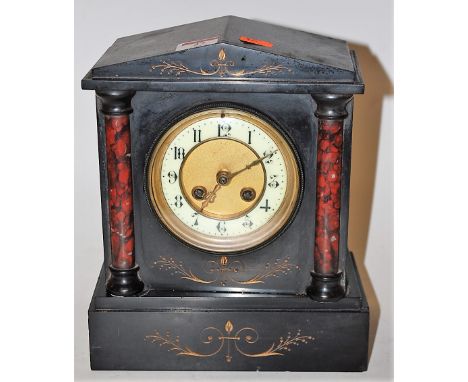 A circa 1900 black slate mantel clock, of architectural form, the enamelled dial with Arabic numerals, eight day movement str