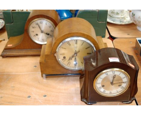A 1930s oak cased mantel clock having silvered dial with Arabic numerals and eight day movement, together with one other waln