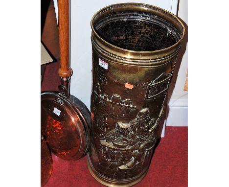 A large early 20th century brass stick-stand, relief decorated with interior tavern scene; together with copper helmet shaped