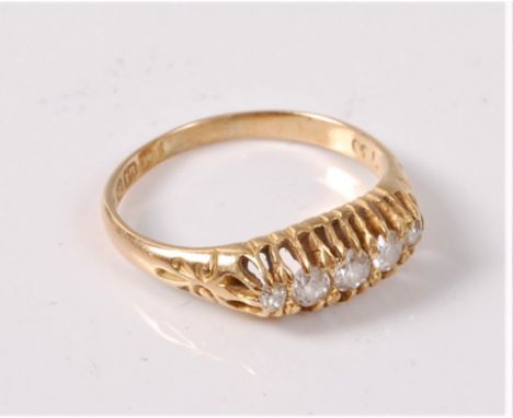 An 18ct diamond ring, the five graduated old cut stones, total estimated approx. 0.33cts, all claw set, to scrolled shoulders
