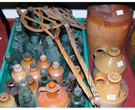 A large collection of assorted stoneware jars, glass bottles, pair of carpet beaters etc 