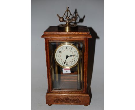 A mid-20th century oak cased four glass mantel clock, having enamelled dial with Arabic numerals, h.33cm