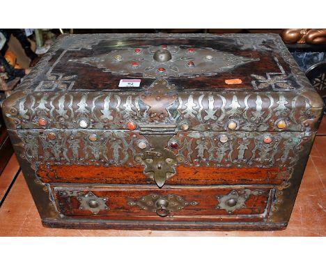A 19th century Eastern hardwood, brass mounted, and cabochon gem inset travelling trunk, having hinged lid above a single sho