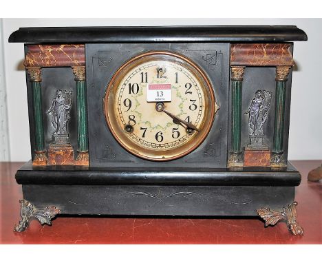 A late 19th century American ebonised cased mantel clock, of architectural form, having enamelled dial with Arabic numerals a