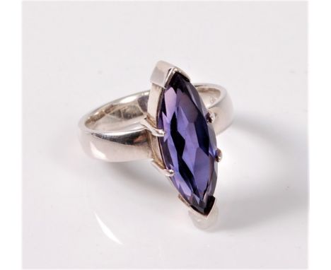 A synthetic sapphire ring, the marquise shaped sapphire, approx. 19.5 x 7.5mm, claw mounted to a plain broad band stamped 925