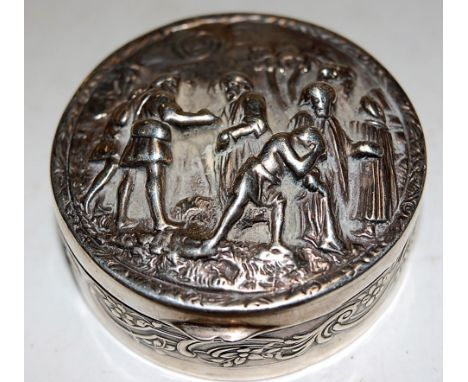 An early 20th century eastern white metal pocket snuff box of circular form, the hinged lid relief decorated with eastern mar