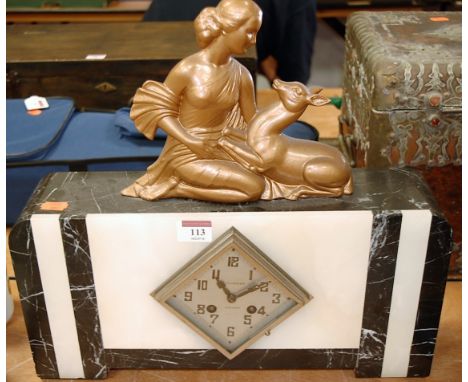 An Art Deco veined marble cased mantel clock, the silvered dial with Arabic numerals and eight day movement, the whole surmou